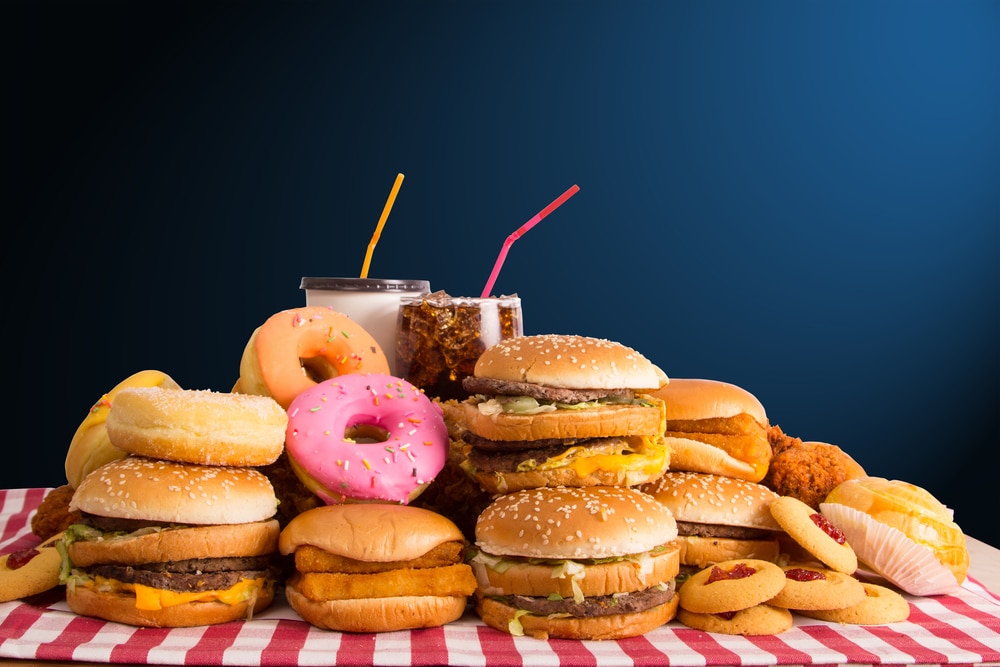 Burgers, Donuts, Cookies, and Drinks on the table that can cause inflammation- Cerulean